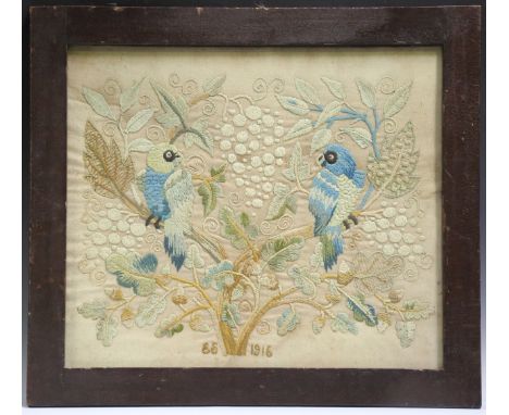 An early 20th century Arts and Crafts woolwork panel, initialled 'E.S.' and dated 1916, worked with a pair of opposing birds 