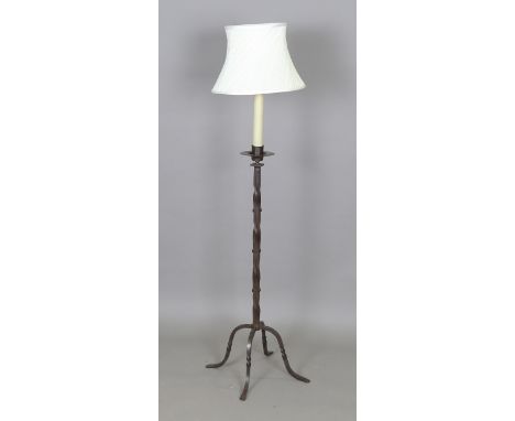An early 20th century Arts and Crafts patinated wrought copper lamp standard, the wrythen sectional column on four downswept 