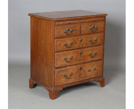 An early 20th century George I style burr walnut bachelor's chest with feather and crossbanded borders, the brushing slide ab