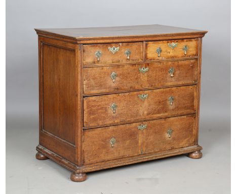 A George I provincial oak chest of drawers with fruitwood crossbanding, raised on bun feet, height 88cm, width 97cm, depth 55