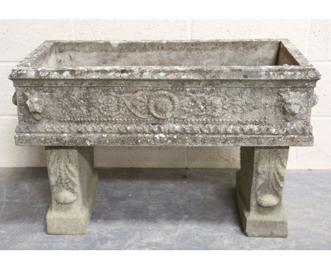 A 20th century cast composition stone rectangular garden planter, moulded in relief with medallions and lions' masks, raised 