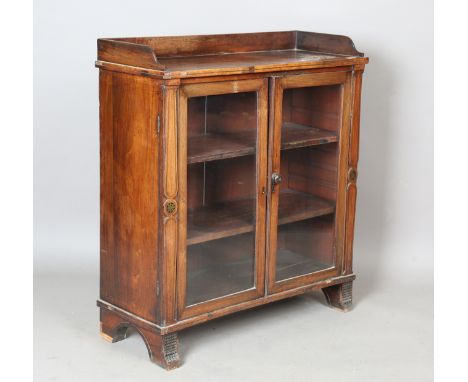 A Regency mahogany and brass inlaid side cabinet, the glazed doors enclosing shelves, height 94cm, width 86cm, depth 33cm (fa