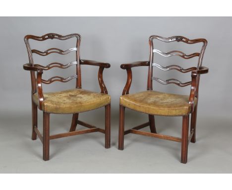 A set of ten early 20th century George III style mahogany pierced and carved ladder back dining chairs with khaki leather sea
