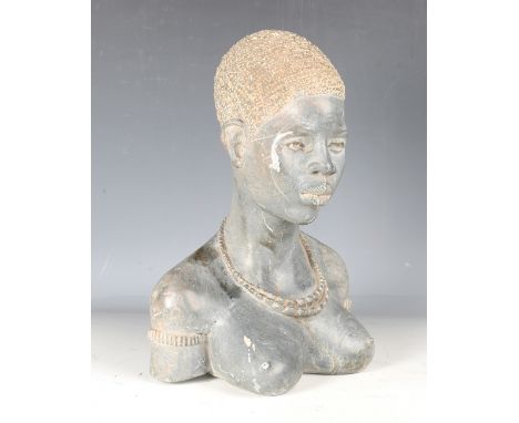 A late 20th century African carved stone head and shoulders portrait bust of a young woman, inscribed 'Shad' to underside, he