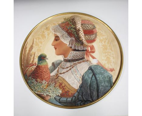 A large Aesthetic Movement art pottery circular charger, modelled in low relief and painted with a head and shoulders portrai