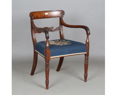A late Regency mahogany bar back armchair, the centre rail carved with a scallop shell flanked by bird's mask scrolls, the se