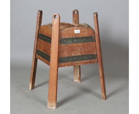 An early 20th century Arts and Crafts oak planter, in the manner of Liberty &amp; Co, the four sides with applied anodized co