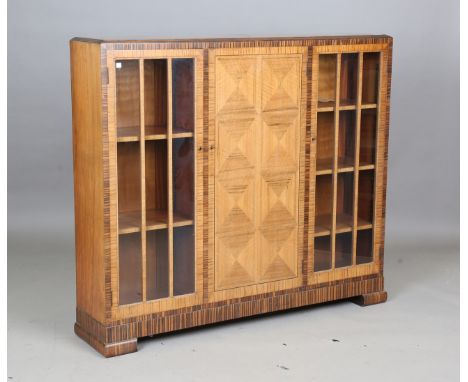 An Art Deco walnut and coromandel crossbanded bookcase by Heal &amp; Son Ltd, height 114cm, width 130cm, depth 29cm.Buyer’s P