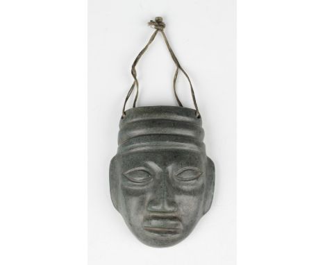 A pre-Columbian Mayan style carved green hardstone mask, possibly 400-800 AD, with pierced holes to top corners, bearing coll