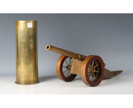 A First World War period engraved brass shell case, detailed 'Ypres', height 23cm, together with a trench art model of a fiel