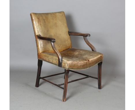 An early 20th century George III style mahogany framed Gainsborough armchair, upholstered in tan leather, the handrests finel