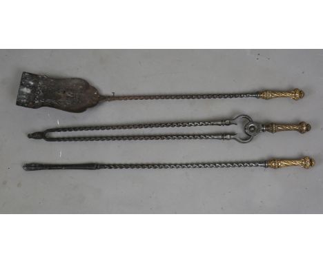 A set of three George III steel fire tools, each with a foliate chased spiral reeded cast brass handle, length 80cm. Note: fr