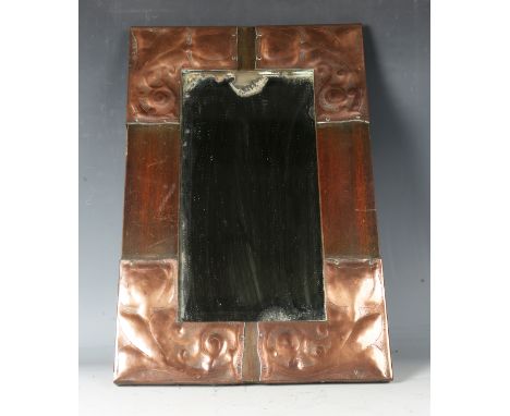 An early 20th century Arts and Crafts stained beech and copper mounted wall mirror with a bevelled plate glass, 46cm x 30cm.B
