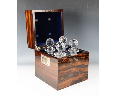 An early 20th century coromandel four-bottle decanter case, the front with inset initialled plaque, the sides with recessed h