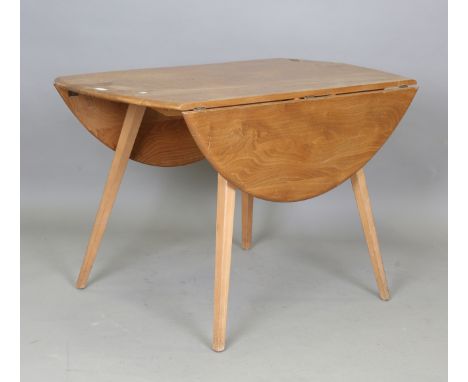 An Ercol elm drop-flap oval kitchen table, height 71cm, length 123cm, depth 113cm.Buyer’s Premium 29.4% (including VAT @ 20%)