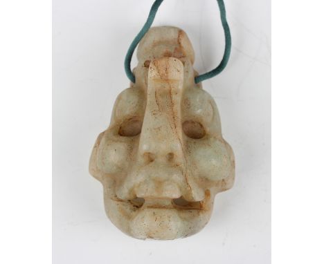 A pre-Columbian Mayan style carved pale green hardstone mask, possibly 400-800 BC, modelled possibly representing the transfo