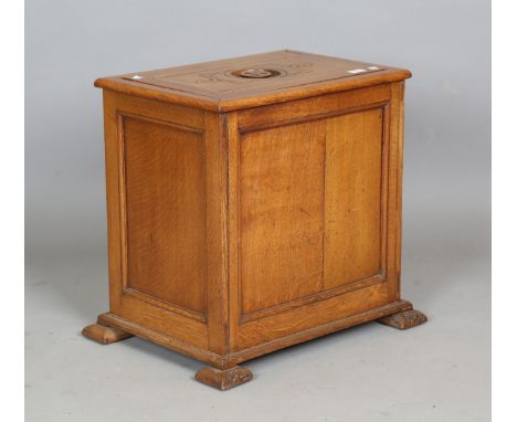 An early 20th century Arts and Crafts oak cellarette, the removable inset lid revealing a tin-lined interior, height 55cm, wi