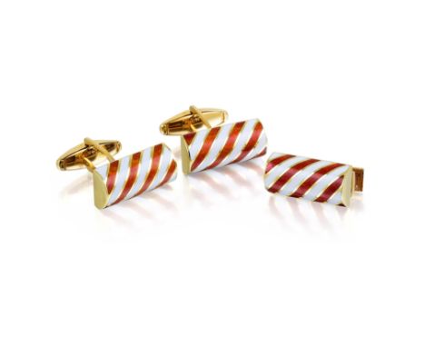 Comprising a pair of cufflinks and a stud; crafted out of 14K yellow gold, enhanced with enamel; weight 24g. Signed CARTIER; 