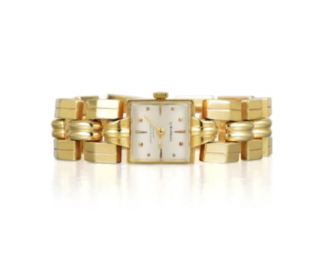 Designed with a geometrical band, crafted out of 14K yellow gold, with a square case, with a manual movement by Patek Philipp