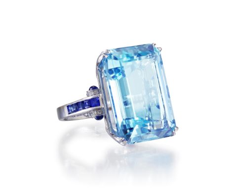 Featuring a very fine aquamarine, weighing 28.65 carats, flanked by 10 square-cut sapphires, weighing approximately 0.60 cara