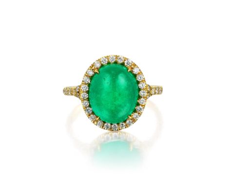 Featuring a centered oval-shaped cabochon emerald, weighing 4.66 carats, surrounded by small brilliant-cut diamonds, weighing