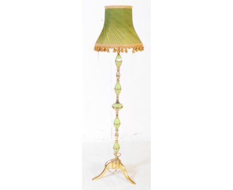 A vintage circa 1970s onyx and brass floor standing standard lamp having oval onyx sections interspersed by brass divisions t