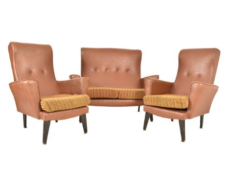 A retro 20th century faux tan brown leather sofa suite. The suite comprising a two seater sofa settee and two matching armcha