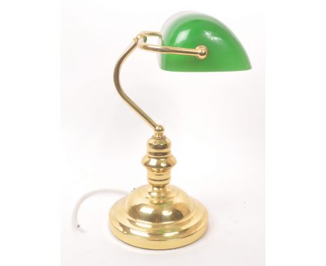 A vintage mid 20th century bankers table top desk lamp light. With a hand blown green glass light shade metal curved support 