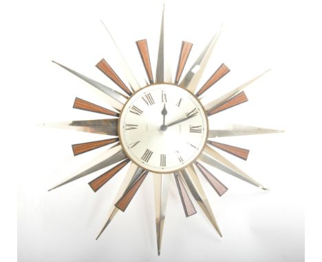 Metamec - A large mid 20th Century retro sunburst hanging wall clock by Metamec. Having silver face with ebonised chapter rin