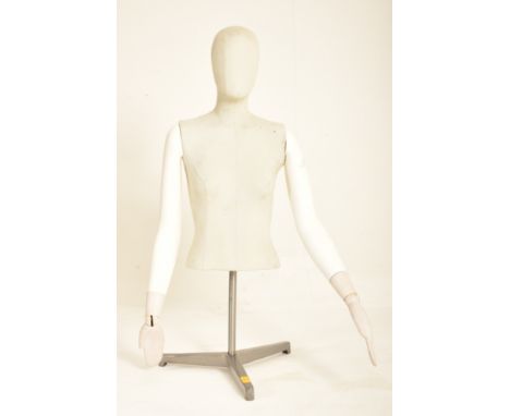 A contemporary point of sale shop display half mannequin on stand. The mannequin having a plain face with articulated arms wi