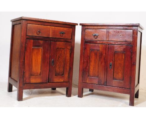 A pair of contemporary hardwood bedside cabinets. The cabinet having crossbanded top over twin drawers over twin door cabinet