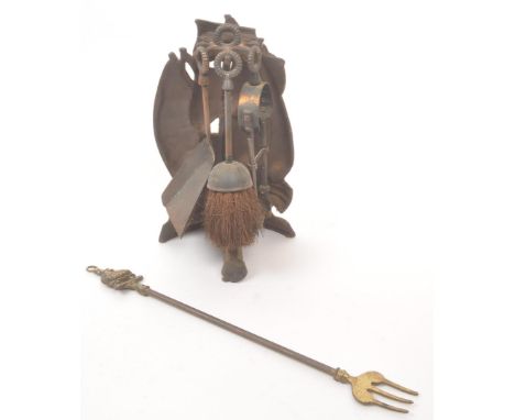 An early 20th century cast metal novelty ships fireside companion set. The set in the form of a sail ship, with fireside tool