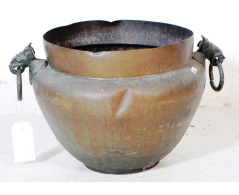 A 19th century Anglo Indian copper planter. The planter having twin handles to each side cast in the form of elephant masks w