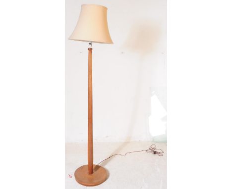 A mid 20th century circa 1960s teak Danish influence standard floor standing lamp. The lamp having tapering shaft over concav