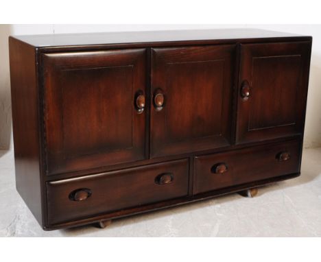 Ercol - Model 468 - A mid 20th century Ercol Model 468 beech and elm wood sideboard. The sideboard featuring a series of thre