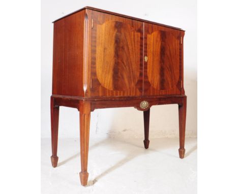 Harrods - A 20th century Harrods walnut cocktail cabinet. The cabinet having glazed top cocktail cabinet. The cabinet having 