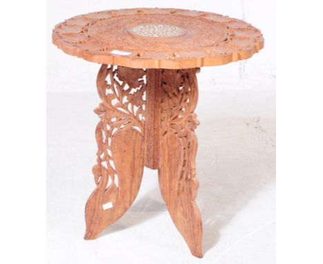 A vintage 20th century Indian carved occasional / coffee table. With carved repeating foliate design, with inlaid decoration 