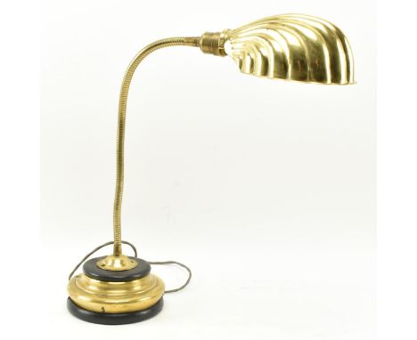 A vintage 20th century Art Deco brass desk lamp light. The lamp with circular plinth base, adjustable goose neck and scallop 