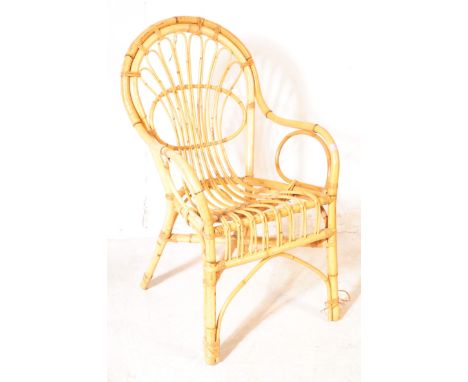 A 20th Century circa 1970s vintage bamboo chair having rounded backrest with fan like design. Measuring approx. 94cm x 56cm x