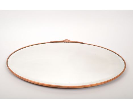 Art Nouveau manner copper effect wall hanging mirror. Of oval form with central glass panel bevelled edge. Decorative motif t