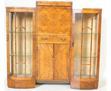 An Art Deco burr walnut veneer bookcase / drinks cocktail cabinet. Having a central drop down cabinet single drawer above ano