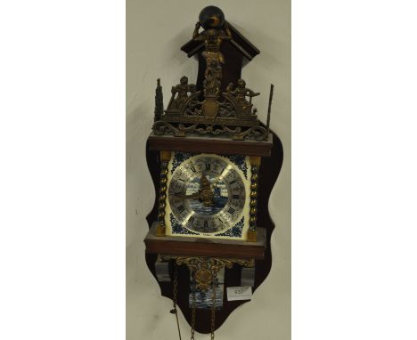 A Dutch mahogany wall clock with large pear brass weights, the clock with decorative gilt metal mounts over brass chapter rin