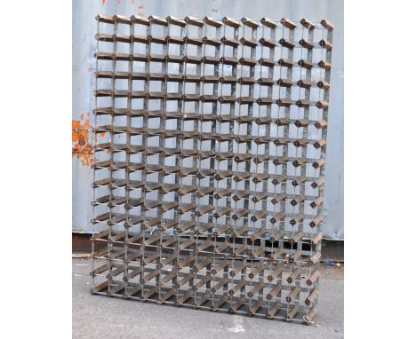 A large vintage 20th century bottle / wine rack stand. Having square wooden supports all connect by metal frame. 180 spaces. 
