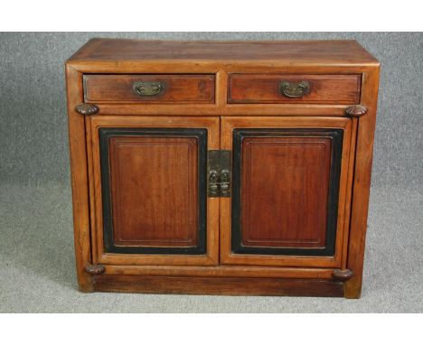 Sideboard, Chinese hardwood with ebonised panel doors on block supports. H.88 W.104 D.48cm. 
