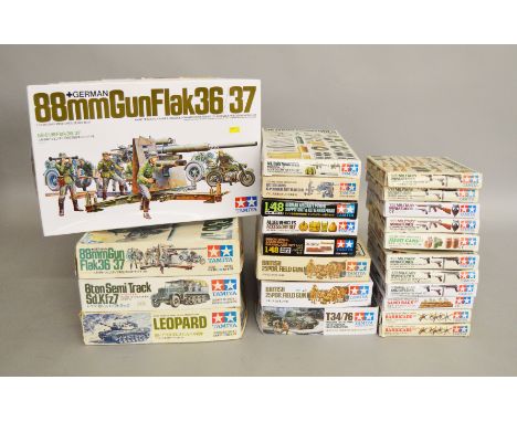 23 boxed Tamiya Military Vehicle kits and Accessory Packs  mostly in 1:35 and 1/48 scales including Leopard Tank, 88mm Gun Fl