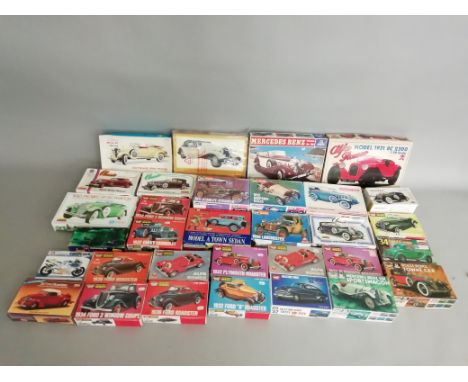 32 boxed, mainly car related, plastic Model Kits by 'Life-Like', Lindberg and others in various different&nbsp; scales, also 
