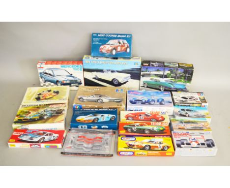 18 boxed car related plastic Model Kits by Heller, Lindberg and others in various different scales, including both Race and R