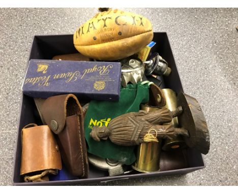 A box of odds to inc a mini rugby ball, canon shells, a Mercedes mascot, mini camera etc