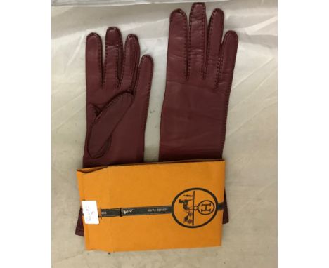 A cased pair of Hermes leather gloves