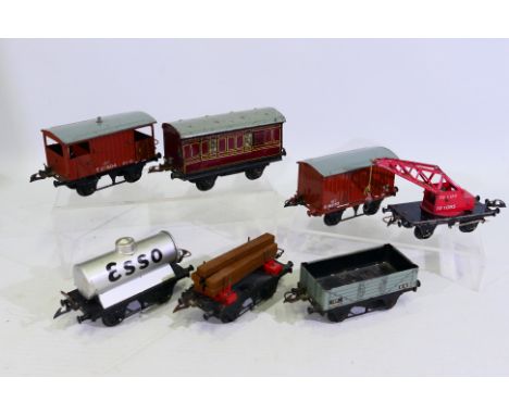 Hornby - A rake of seven unboxed Hornby O gauge freight rolling stock. Lot includes Hornby Esso Tanker; 10 Ton Crane Truck; L